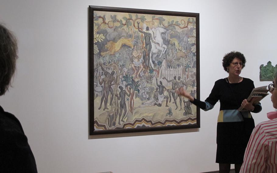 A member of the staff of the museum leads a tour.