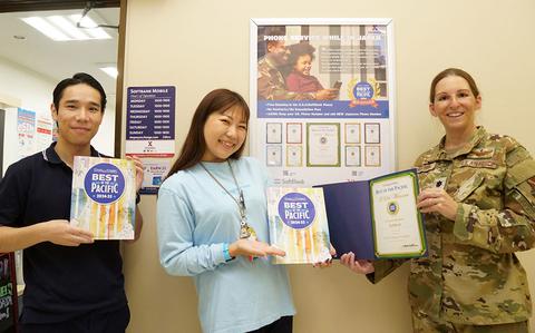 Photo Of Softbank staff group photo as Stars and Stripes Pacific Commander Lt. Col. Marci Hoffman presents award.