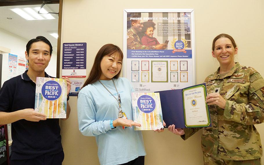 Softbank staff group photo as Stars and Stripes Pacific Commander Lt. Col. Marci Hoffman presents award.