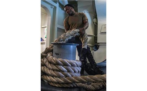 Photo Of Boatswain’s Mate 2nd Class Maurice Morris, from New York, assigned to deck department’s forward division, gives training on mooring operations.