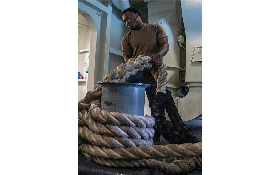 Boatswain’s Mate 2nd Class Maurice Morris, from New York, assigned to deck department’s forward division, gives training on mooring operations.