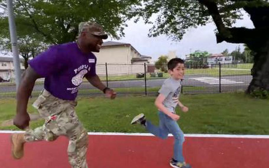 A military personnel and a boy are running.