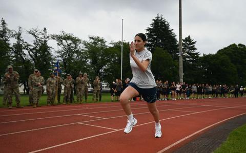 Photo Of U.S. Air Force Airman 1st Class Cecilia Quintanilla runs on a track during a tour of Kumagaya Air Base, Japan.