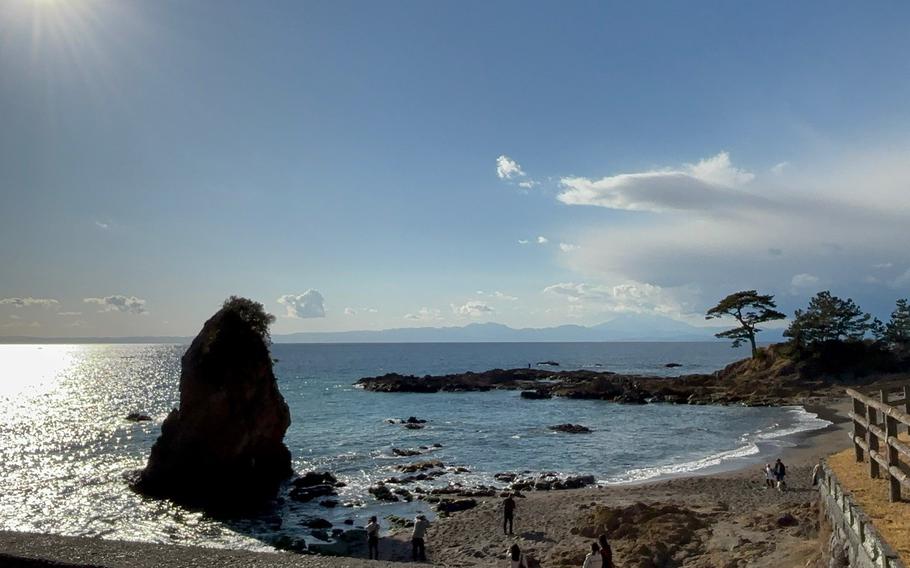 a big rock can be seen on the water’s edge.