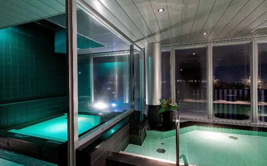 The large bath, with a night view. Guests can use it as many times as they like during their stay.