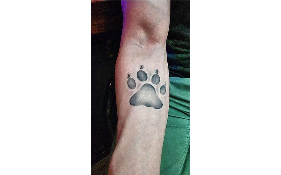 lion’s pawprint on his right arm.