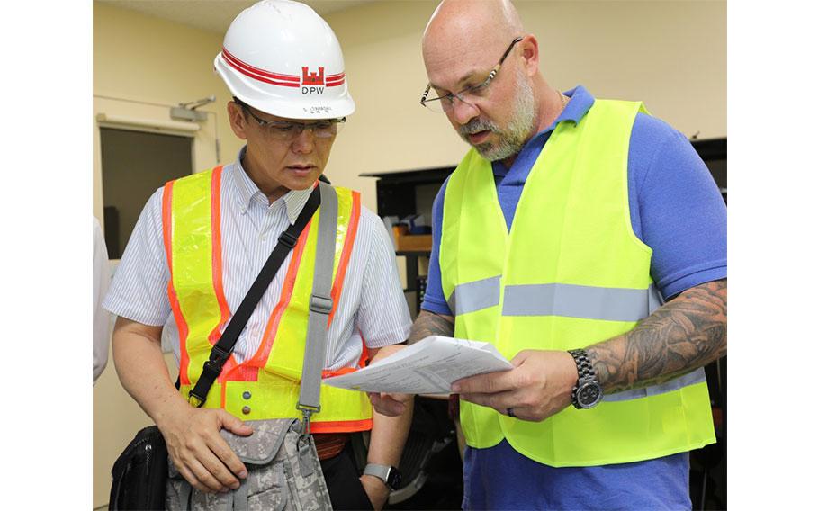 Satoru Itahashi, left, an electrical power dispatcher foreman, and Eli Craft, chief of operations and maintenance for U.S. Army Garrison Japan’s Directorate of Public Works, participate in the “Black Start” exercise at Camp Zama, Japan, July 2, 2024. The exercise tested the installation’s energy resilience by having backup systems kick in during the power outage drill. 