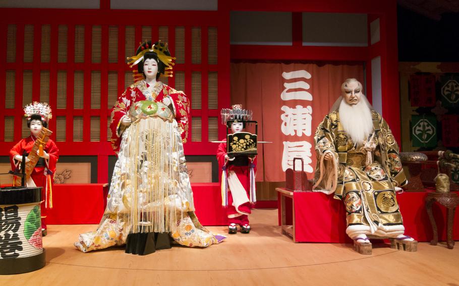Some performers’ dolls are displayed.