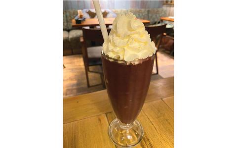 Photo Of A beverage with whipped cream on the table.