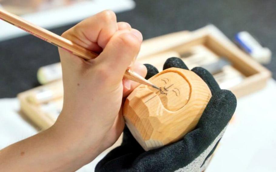A participants enjoy Buddhist statuette carving.