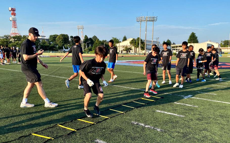Joshua Cisneros, co-founder of the Japan Gridiron Association (JGA) coaches student athletes participating in football drills.