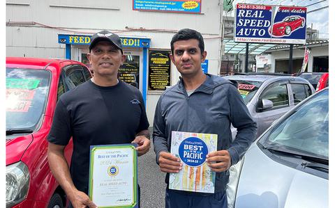 Photo Of Real Speed Auto staff pose with award and best of the pacific magazine.