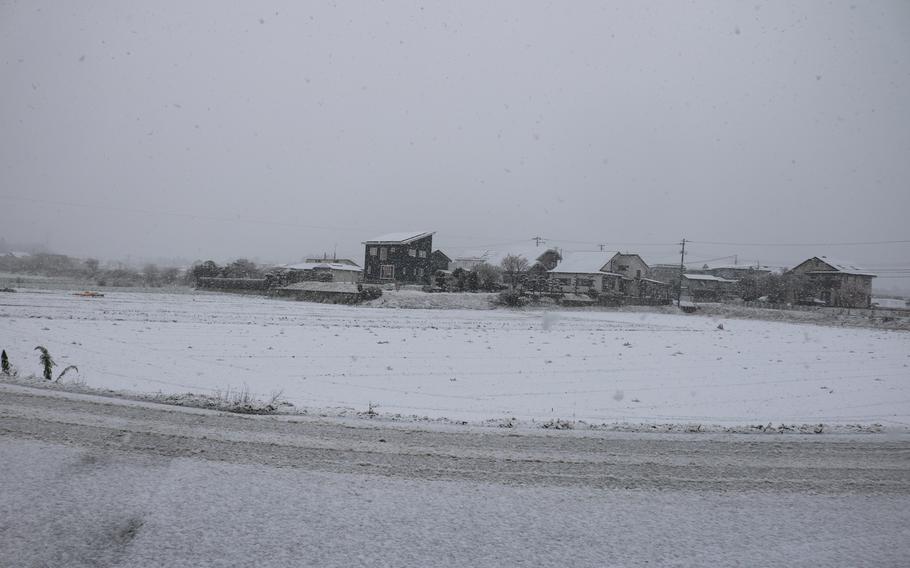 snow is falling on the houses.