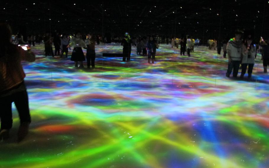 Visitors enjoy one of the exhibitions at teamLab Planets.