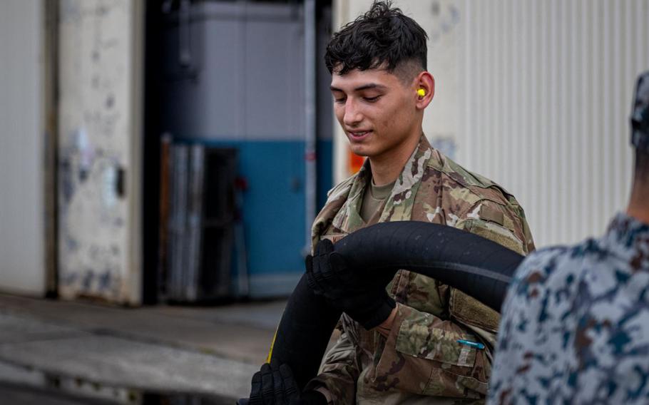 U.S. Air Force Airman 1st Class Andrew Mikel pulls a fuel hose before fueling a U.S. Air Force HH-60 Pave Hawk during exercise Resolute Force Pacific (REFORPAC) 2025 at Misawa Air Base, Japan, July 15, 2025.