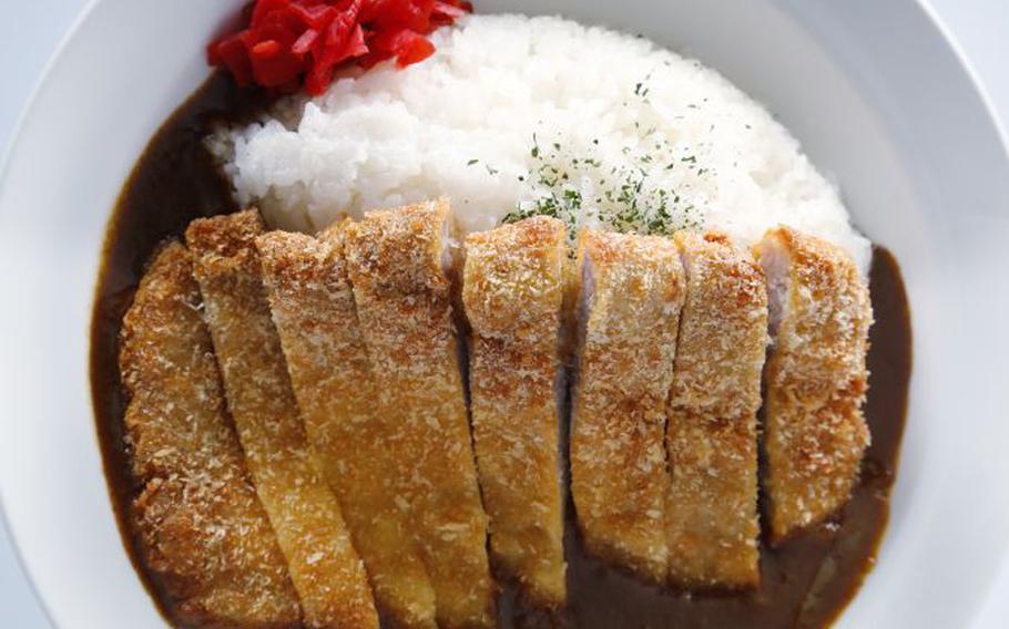 The most popular version of Japanese curry is katsu (cutlet) curry, accompanied by rice and bright-red pickled ginger.