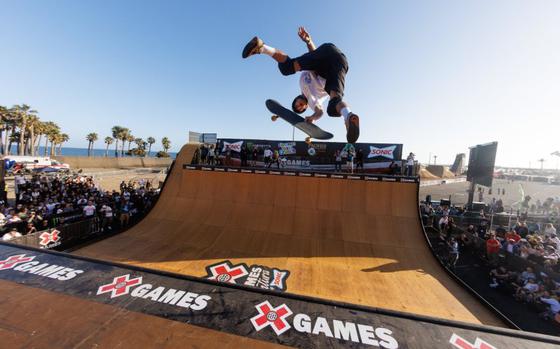 Photo Of a player is jumping with his skateboard.