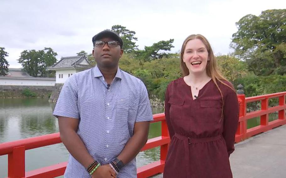 Two people standing on the bridge in Odawara Castle.
