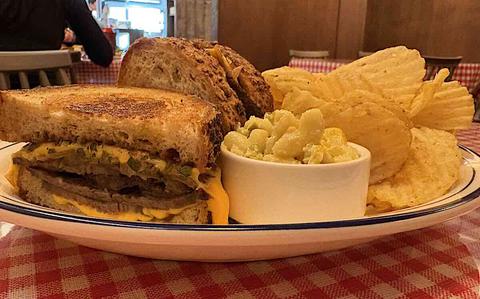 Photo Of Sandwiches and potato chips on a plate.