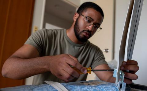 Photo Of A U.S. Air Force Airman assigned to the 35th Fighter Wing (FW) assembles a portable air conditioning unit frame tobe installed in a contingency dormitory for Exercise Resolute Force Pacific (REFORPAC) at Misawa Air Base.