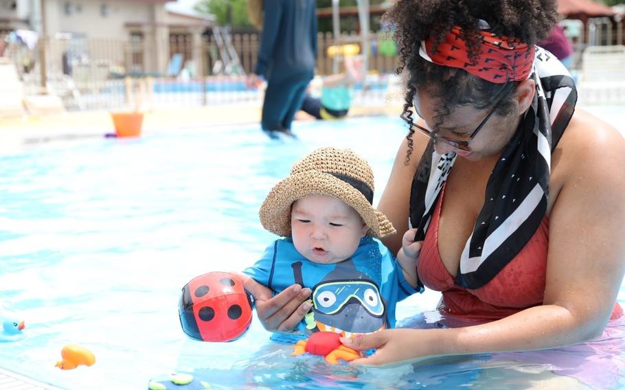 Erica Riggeal plays with her son at the Sagamihara Housing Area outdoor swimming pool July 19 during an Army Community Service-hosted child-parent bonding pool playgroup.