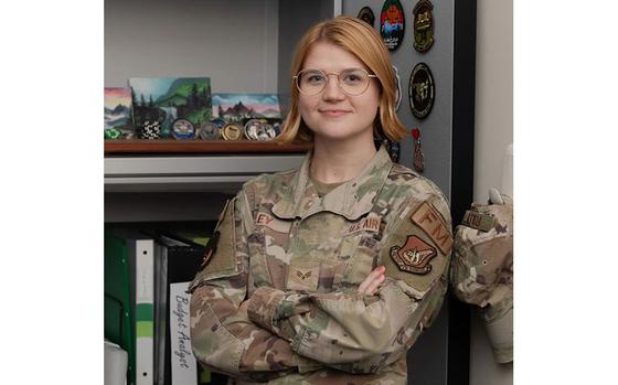 Photo Of U.S. Air Force Senior Airman Alison Riley smilingly holds her arms.