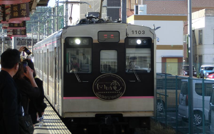 A train on the Iizaka Line is arriving at Fukushima Station.