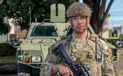 Photo Of U.S. Air Force Airman 1st Class Jose Castro poses for a photo in front of a military vehicle during exercise Guard and Protect 2024 in support of Keen Sword 25 at Yokota Air Base, Japan, Oct. 30, 2024. 