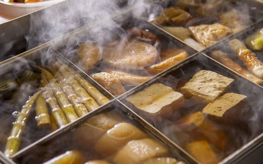 oden in a convenience store. each food is seperated by partitions.