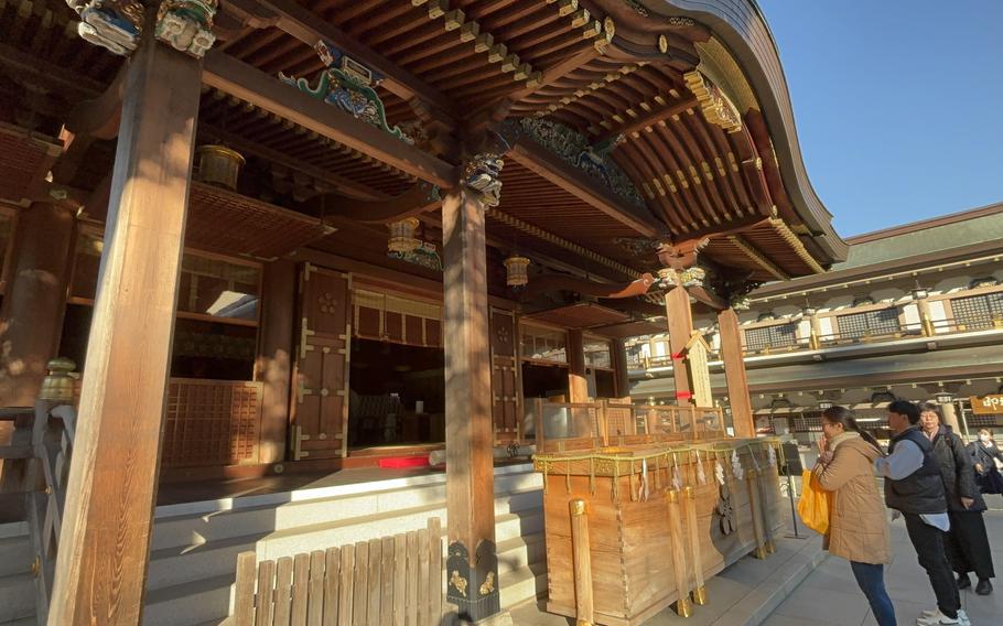 visitors are praying in front of the shrine.