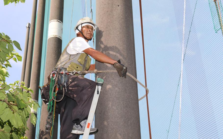 A contractor prepares to fix a net at the Camp Zama Golf Course’s driving range in Japan Aug. 19, 2024. The course is currently undergoing extensive repairs to its mesh nets as part of an ongoing effort to keep balls inside the course area.