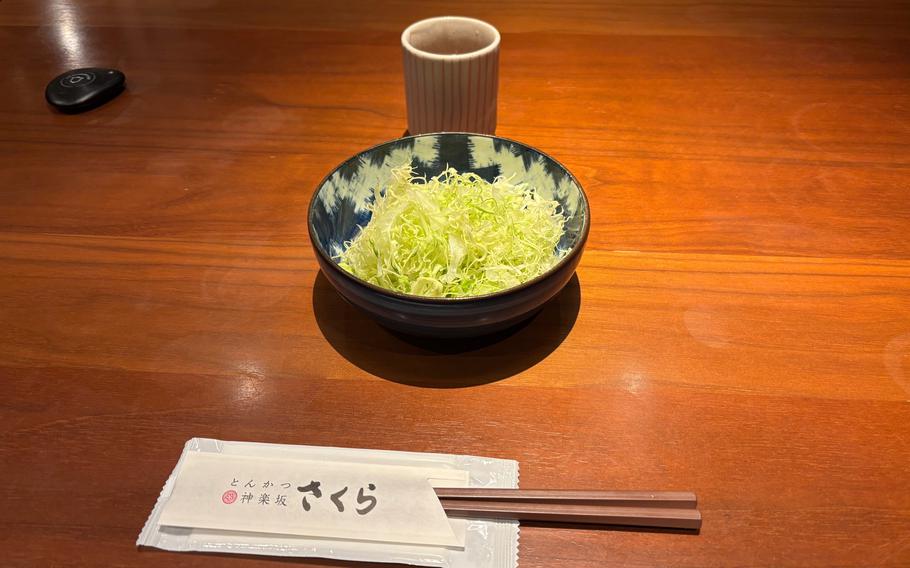 A plate of shredded cabbage and a cup of tea.
