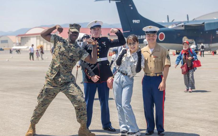 A visitor of Marine Corps Air Station Iwakuni’s Family Day air show poses for a photo with U.S. Marines during Family Day at MCAS Iwakuni, Japan, May 4, 2024. This first iteration of Family Day and Inclusive Day at MCAS Iwakuni allowed both U.S. and Japanese members of the MCAS Iwakuni community, their family members, local orphanages, and members of the local community with special needs the ability to experience a small-scale Friendship Day during the air show rehearsal that showcased the strength of the U.S.-Japan alliance.