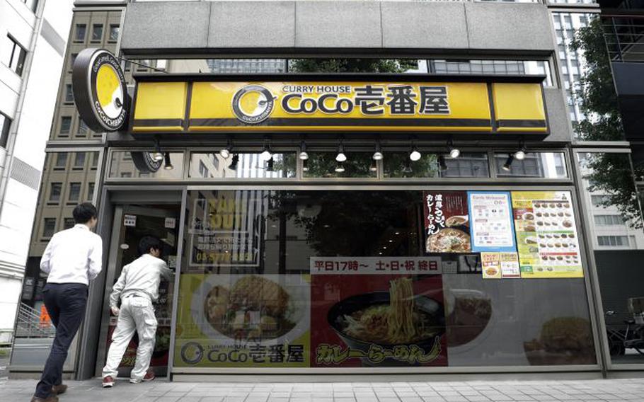 Customers enter a Curry House CoCo Ichibanya restaurant, in Tokyo, Japan.