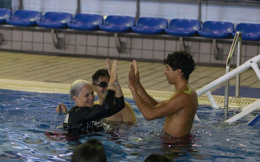 Jennifer Ayers, the Marine Corps Air Station Iwakuni aquatic director and a South Carolina native, high-fives a swim instructor during instructor training in the Marine Corps Community Services’ indoor pool on Sept. 4, 2024. Ayers and the MCAS Iwakuni aquatics team provide swim clinics and master classes, and train instructors with the goal to improve service members’ survival skills and increase their water confidence.