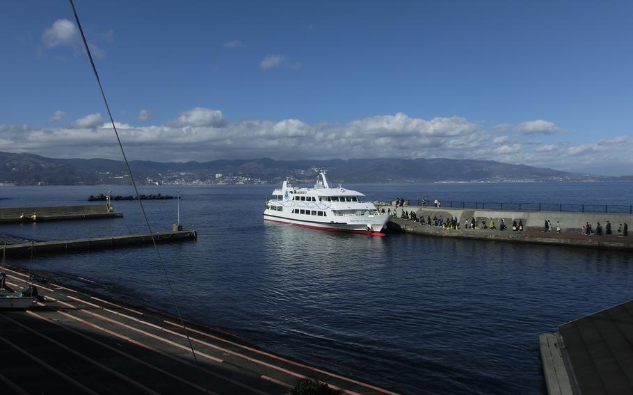 Passengers embark on a high-speed boat at Atami Harbor.