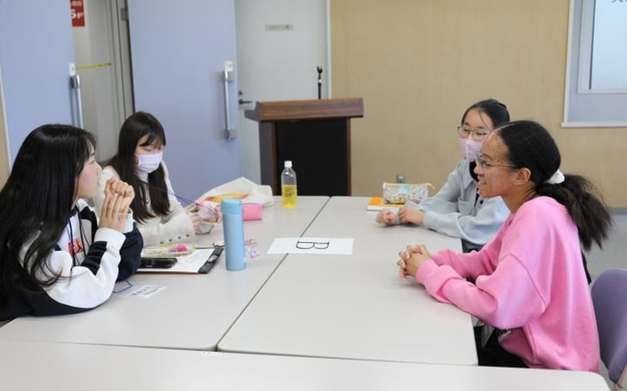 Mikayla Hyori Reese, a Zama American Middle School student from Camp Zama (right) talks to Japanese youth at a cultural exchange event held Feb. 11 at Zama City Hall to help them prepare for an upcoming trip to the United States.