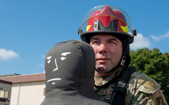 Photo Of U.S. Air Force Lt. Col. Darrick Duran, 374th Mission Support Group deputy commander, carries a dummy during the fire muster challenge at Yokota Air Base, Japan, Sept. 13, 2024. During the competition, teams participated in spraying water from a fire hose, throwing and rolling a fire hose and truck tire flips.