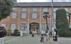 Some visitors are taking photos in front of the East Cocoon Warehouse.