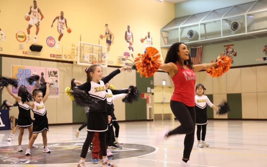 One of the visiting NFL cheerleaders, right, dances with children at a cheerleading clinic held at the Camp Zama Youth Center on Feb. 10.