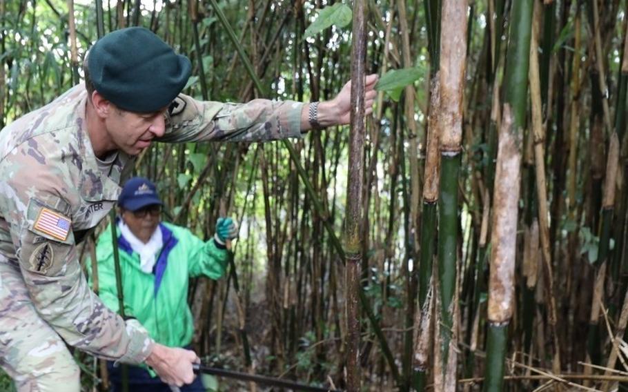 U.S. Army Garrison Japan Commander Col. Marcus Hunter cuts bamboo.