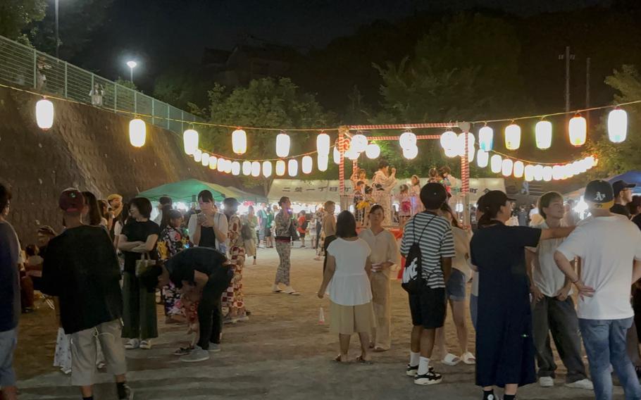 Visitors are in a festive mood. Some lanterns can be seen.