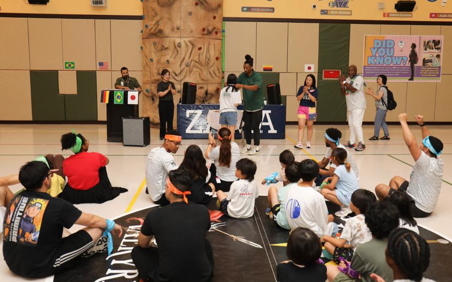 Camp Zama volunteers and residents of the Sagamihara Minami Children’s Home participate in a medal ceremony to conclude a mini-Olympics event at the Youth Center at Camp Zama, Japan, July 24, 2024. The event had six sporting activities inside the center’s gym as part of an effort to build friendships in the local community. 