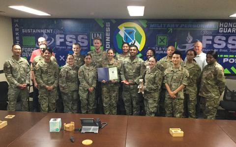 Photo Of Misawa FSS staff group photo as Stars and Stripes Pacific Commander Lt. Col. Marci Hoffman presents award.