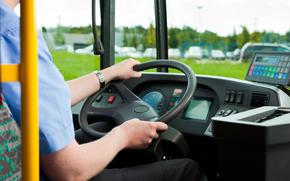 Bus driver sitting in his bus on tour.