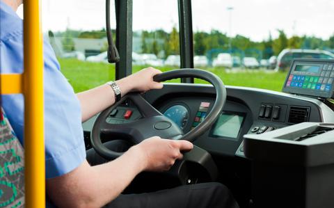 Photo Of Bus driver sitting in his bus on tour.