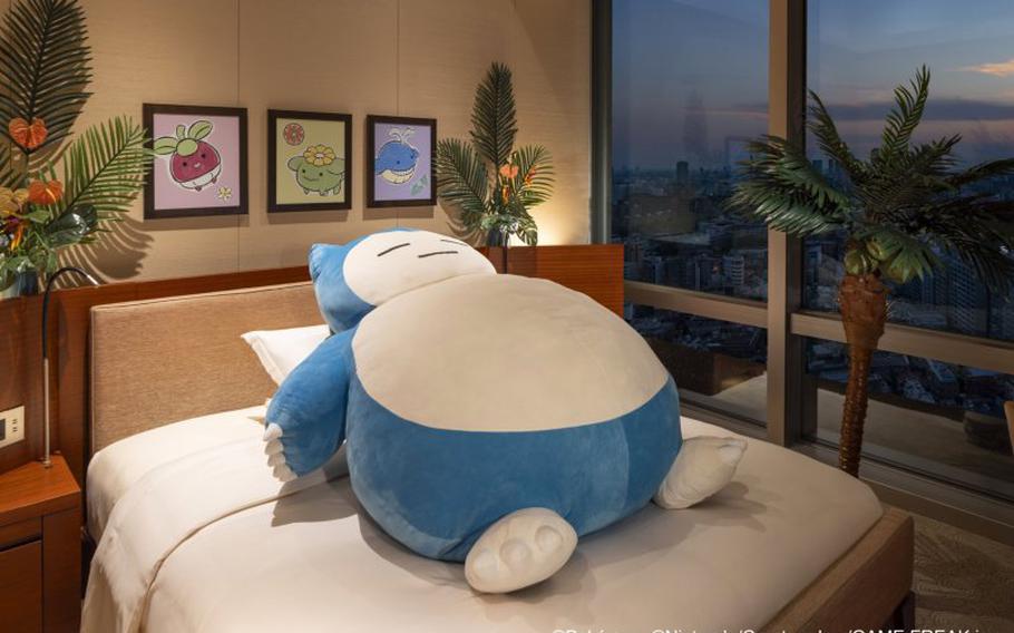 A stuffed pokemon on the bed.