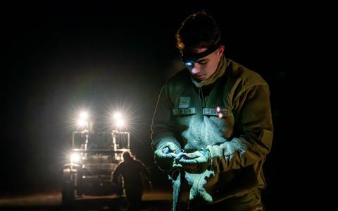 Photo Of 1st Class Aleksander Lepekhin is collecting dropped container delivery system bundles and heavy equipment.