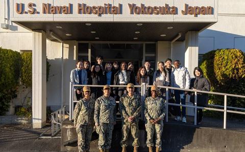 Photo Of USNMRTC Yokosuka members and 14 students pose.