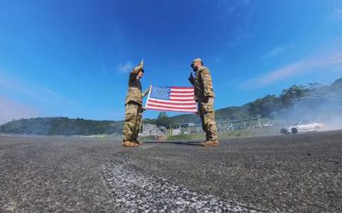 Photo Of Sergeant Isaac Jimenez is taking his oath of reenlistment on the blacktop at Fuji Speedway